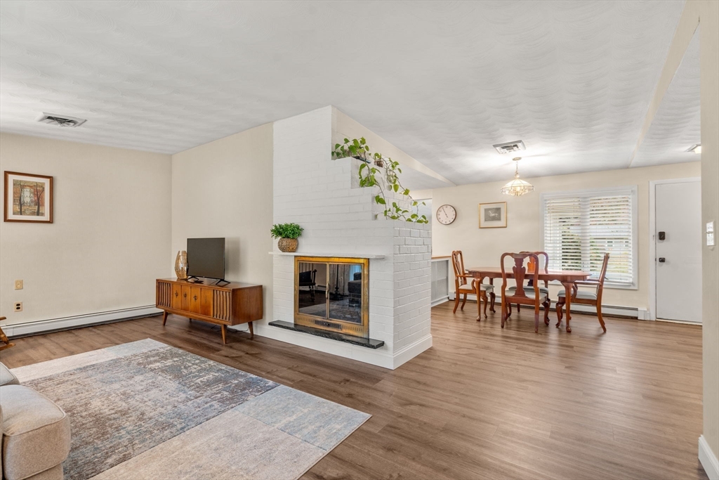 14 Corrine Drive Framingham, MA 01701 - Photo 4 of 15 a living room with furniture and a dining table with wooden floor