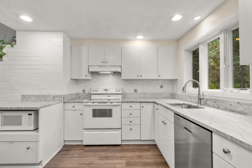 14 Corrine Drive Framingham, MA 01701 - Photo 6 of 15 a kitchen with white cabinets appliances and a sink