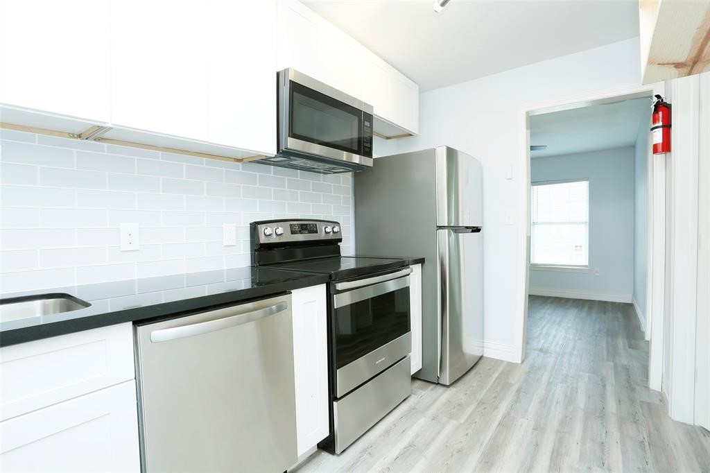 3603 Bastrop Street, Unit 4 Houston, TX 77004 - Photo 5 of 10 a kitchen with stainless steel appliances a refrigerator a stove top oven a sink and dishwasher