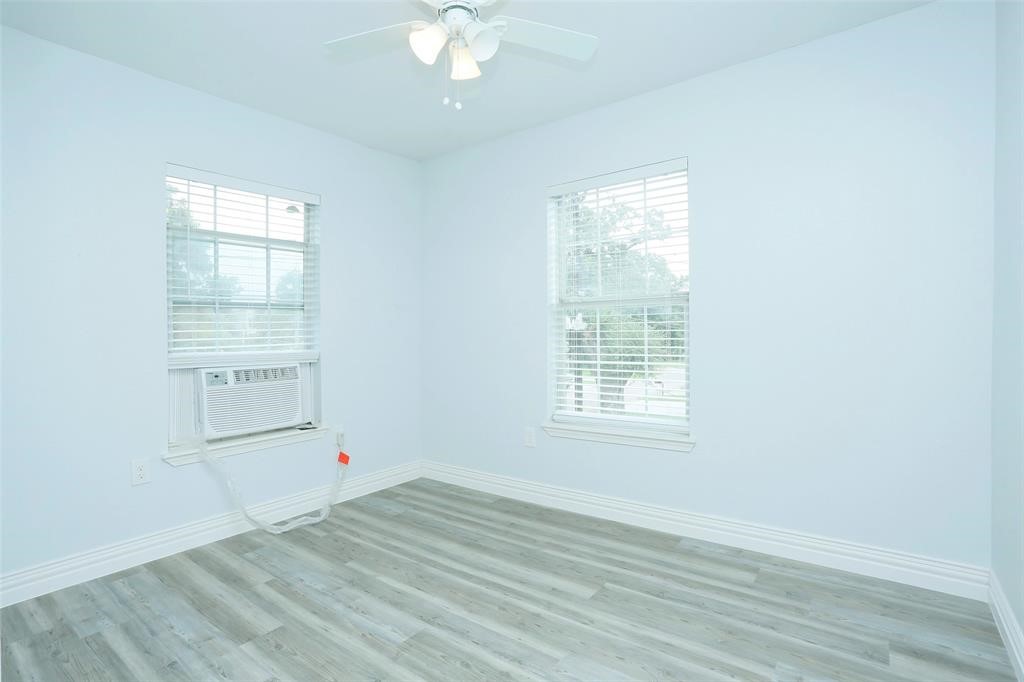 3603 Bastrop Street, Unit 4 Houston, TX 77004 - Photo 6 of 10 an empty room with wooden floor and windows