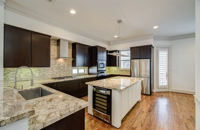 a large kitchen with granite countertop a sink and stove top oven