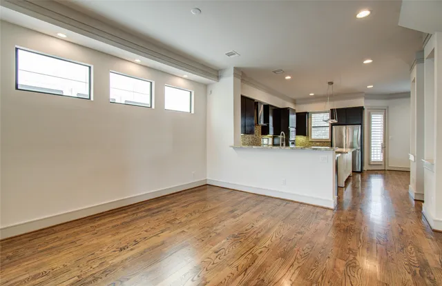 a view of an empty room with a fireplace and a window