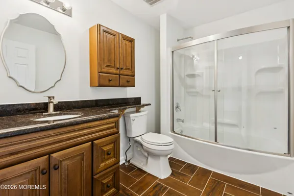 a bathroom with a sink a toilet and a mirror