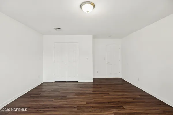 a view of room with wooden floor