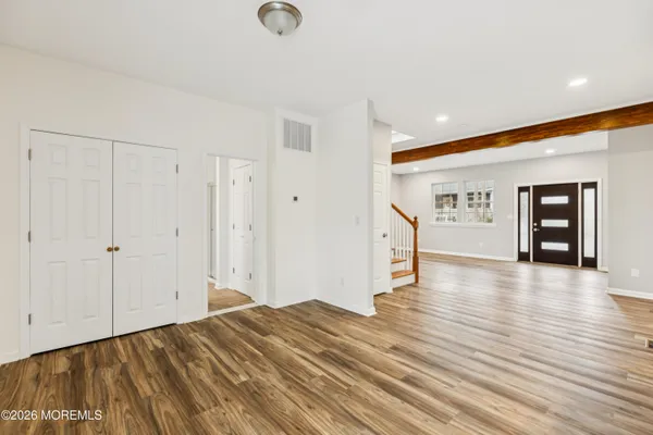 a view of empty room with wooden floor