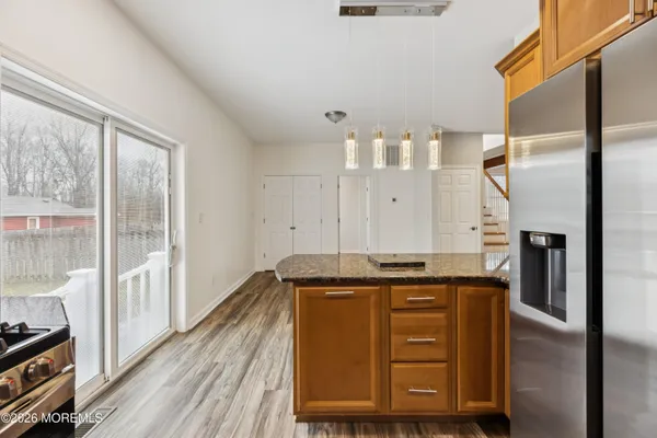 a kitchen with cabinets and wooden floor