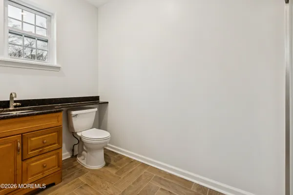a bathroom with a toilet and a window