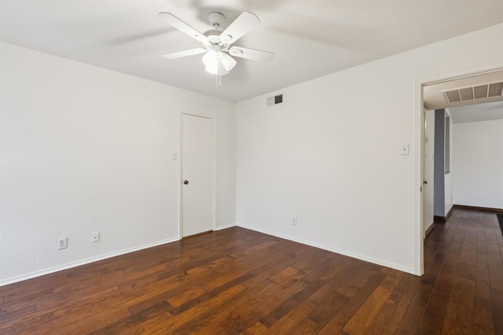 4748 Old Bent Tree Lane, Unit 1808 Dallas, TX 75287 - Photo 11 of 28 an empty room with wooden floor and fan