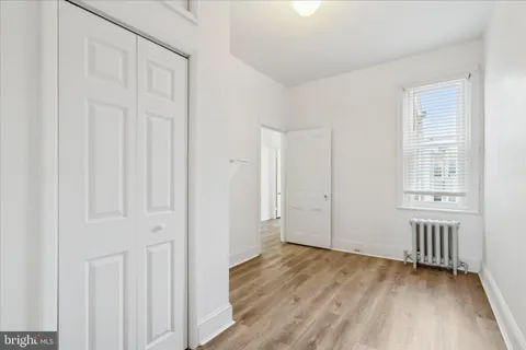 an empty room with wooden floor