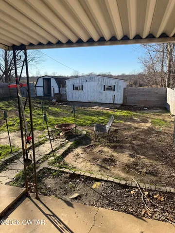 a room with pool table and chairs