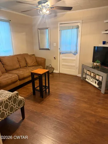 a living room with furniture and a flat screen tv