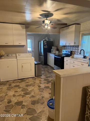 a kitchen with a stove a refrigerator and a sink