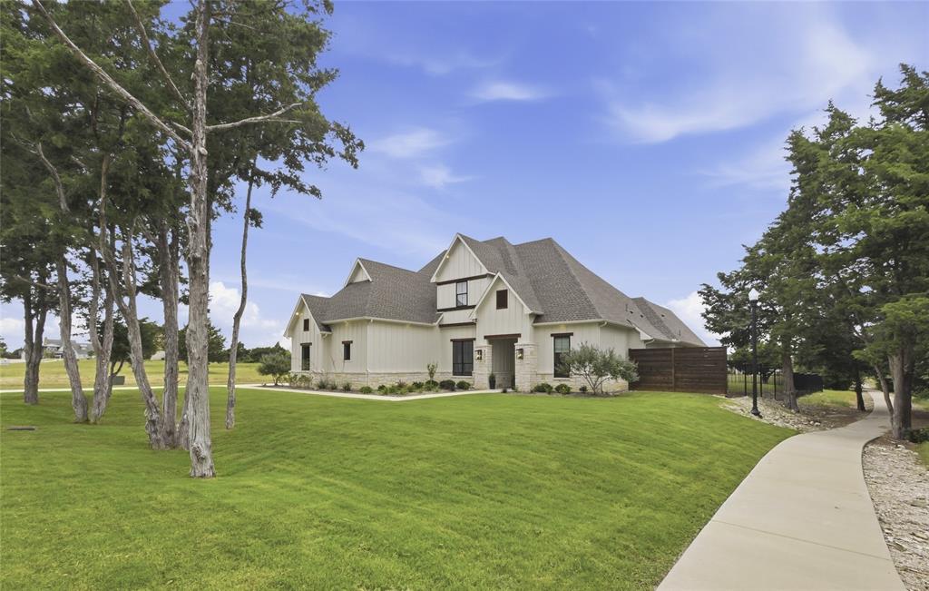 4211 Azalea Way Midlothian, TX 76065 - Photo 2 of 39 Modern farmhouse-style residence with board and batten siding, stone accents, and dark-framed windows