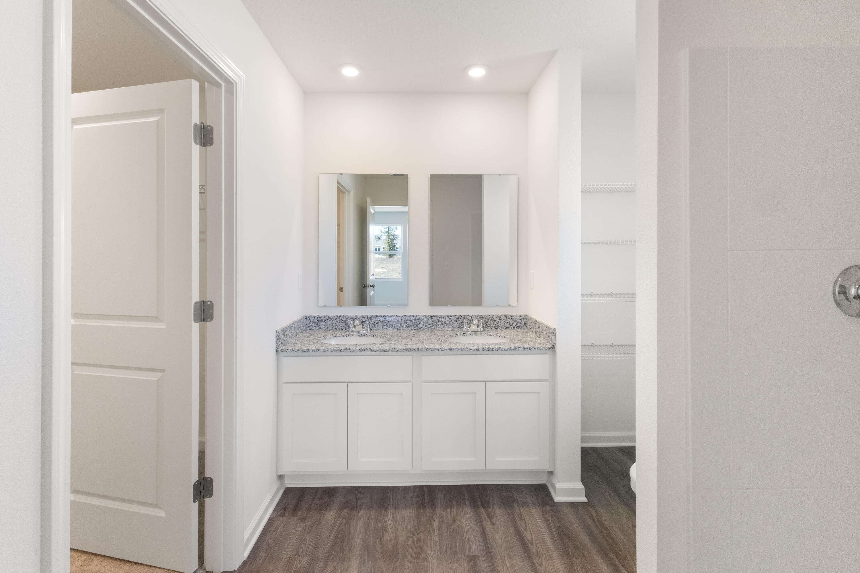 6008 Hidden Knoll Crestview, FL 32539 - Photo 12 of 28 a bathroom with a granite countertop sink a mirror and a shower
