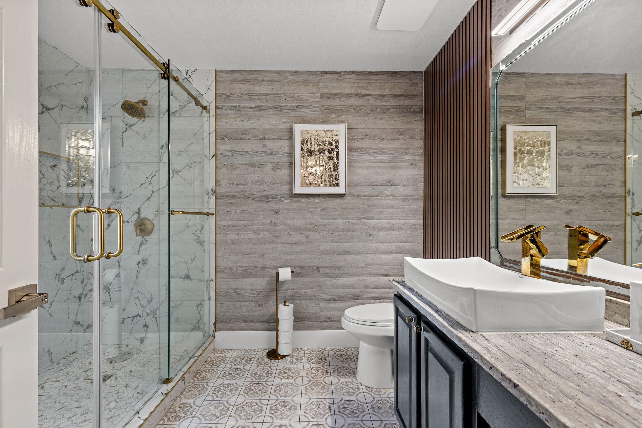 615 Barbara Way Bastrop, TX 78602 - Photo 12 of 27 a bathroom with a granite countertop sink a toilet and shower