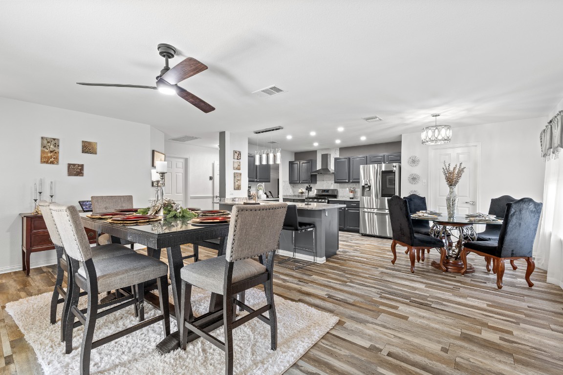 615 Barbara Way Bastrop, TX 78602 - Photo 8 of 27 Dining area with a chandelier, light wood-type flooring, ceiling fan, and recessed lighting