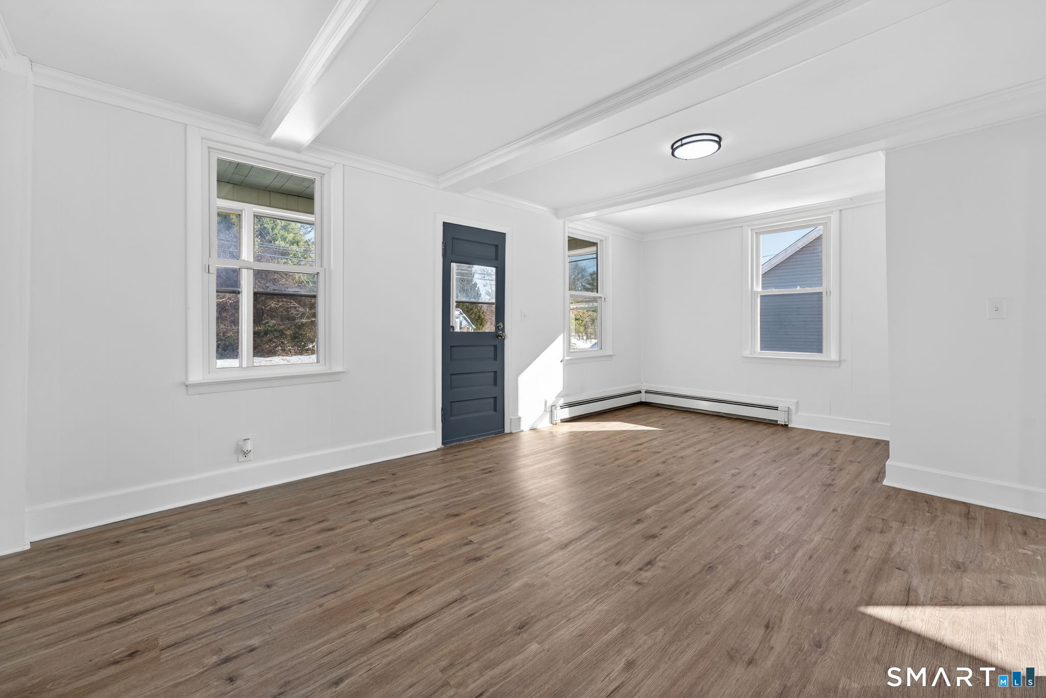 119 Taftville-Occum Road Norwich, CT 06360 - Photo 11 of 27 a view of a big room with wooden floor and windows