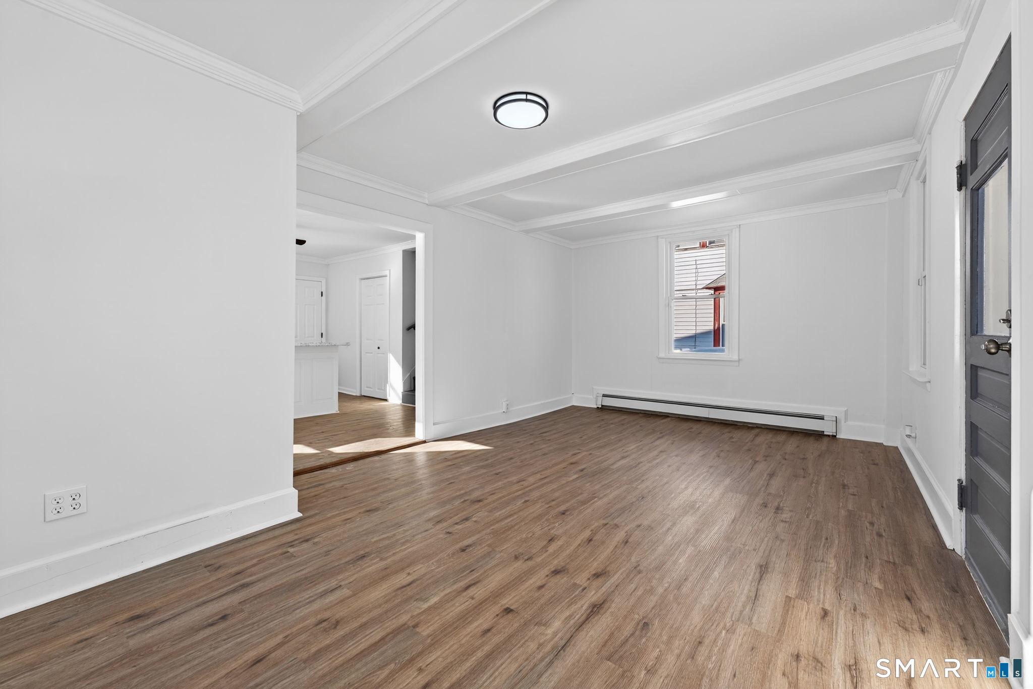 119 Taftville-Occum Road Norwich, CT 06360 - Photo 12 of 27 an empty room with wooden floor and windows