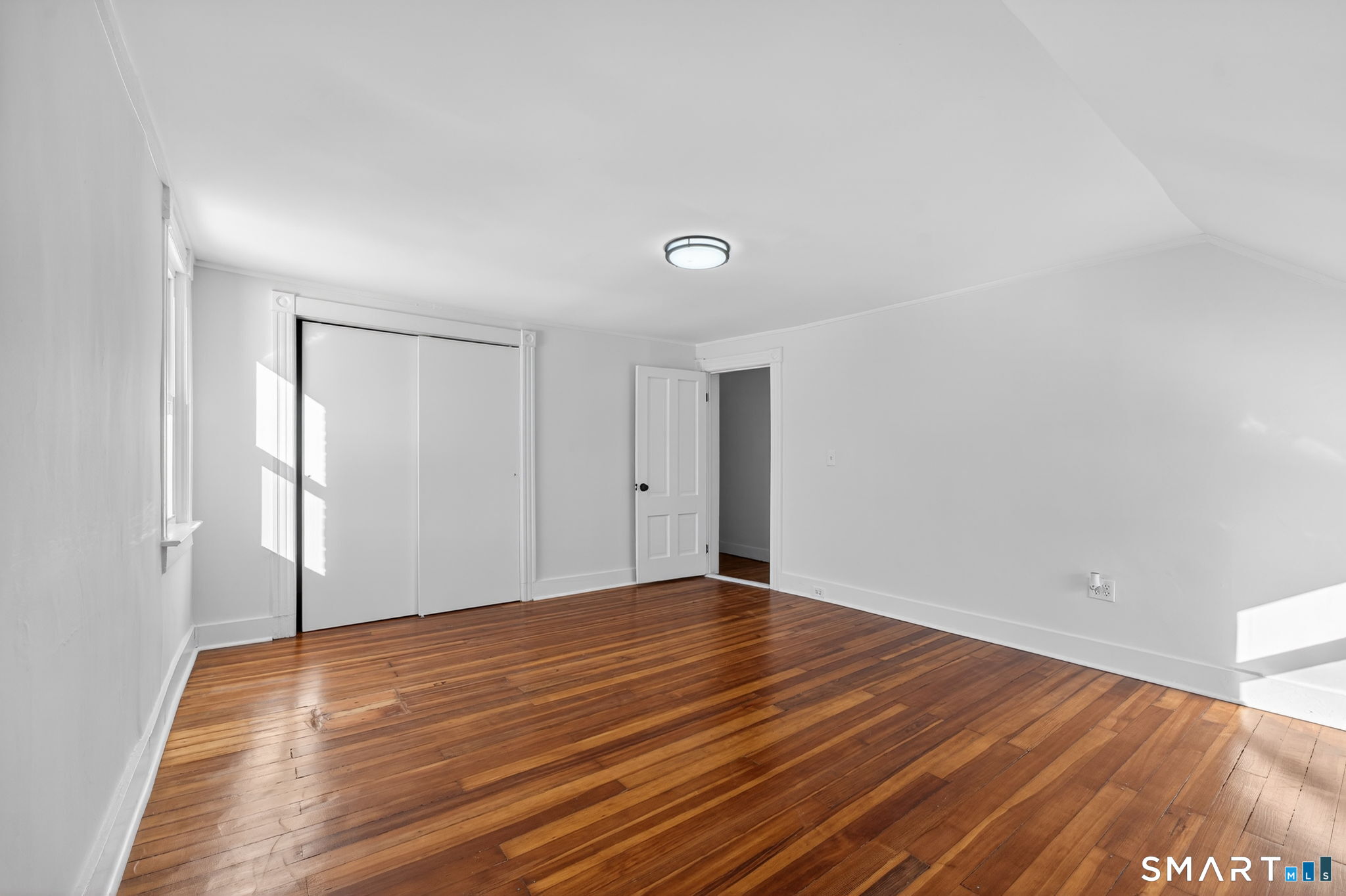 119 Taftville-Occum Road Norwich, CT 06360 - Photo 16 of 27 a view of an empty room with wooden floor