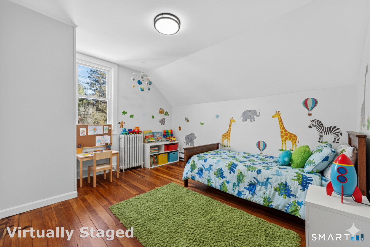 119 Taftville-Occum Road Norwich, CT 06360 - Photo 18 of 27 a bedroom with a bed and a wooden floor