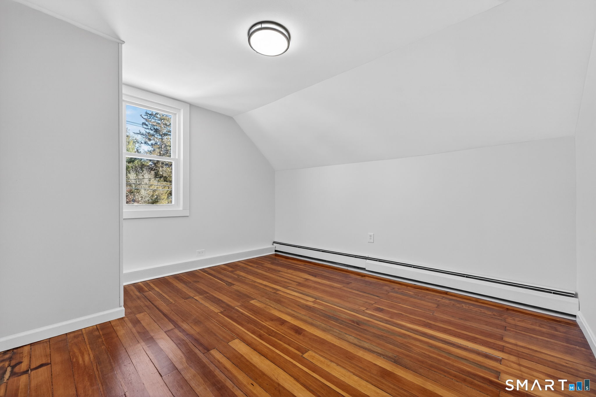119 Taftville-Occum Road Norwich, CT 06360 - Photo 19 of 27 a room with a wooden floor and white walls