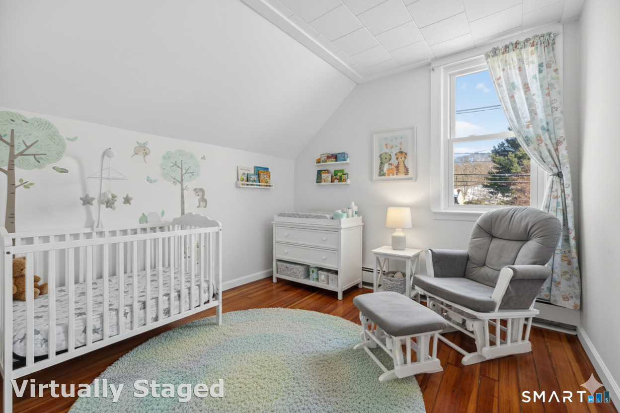 119 Taftville-Occum Road Norwich, CT 06360 - Photo 20 of 27 a bedroom with furniture and a window