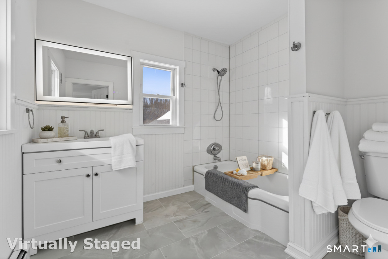 119 Taftville-Occum Road Norwich, CT 06360 - Photo 22 of 27 a bathroom with a sink toilet vanity and tub