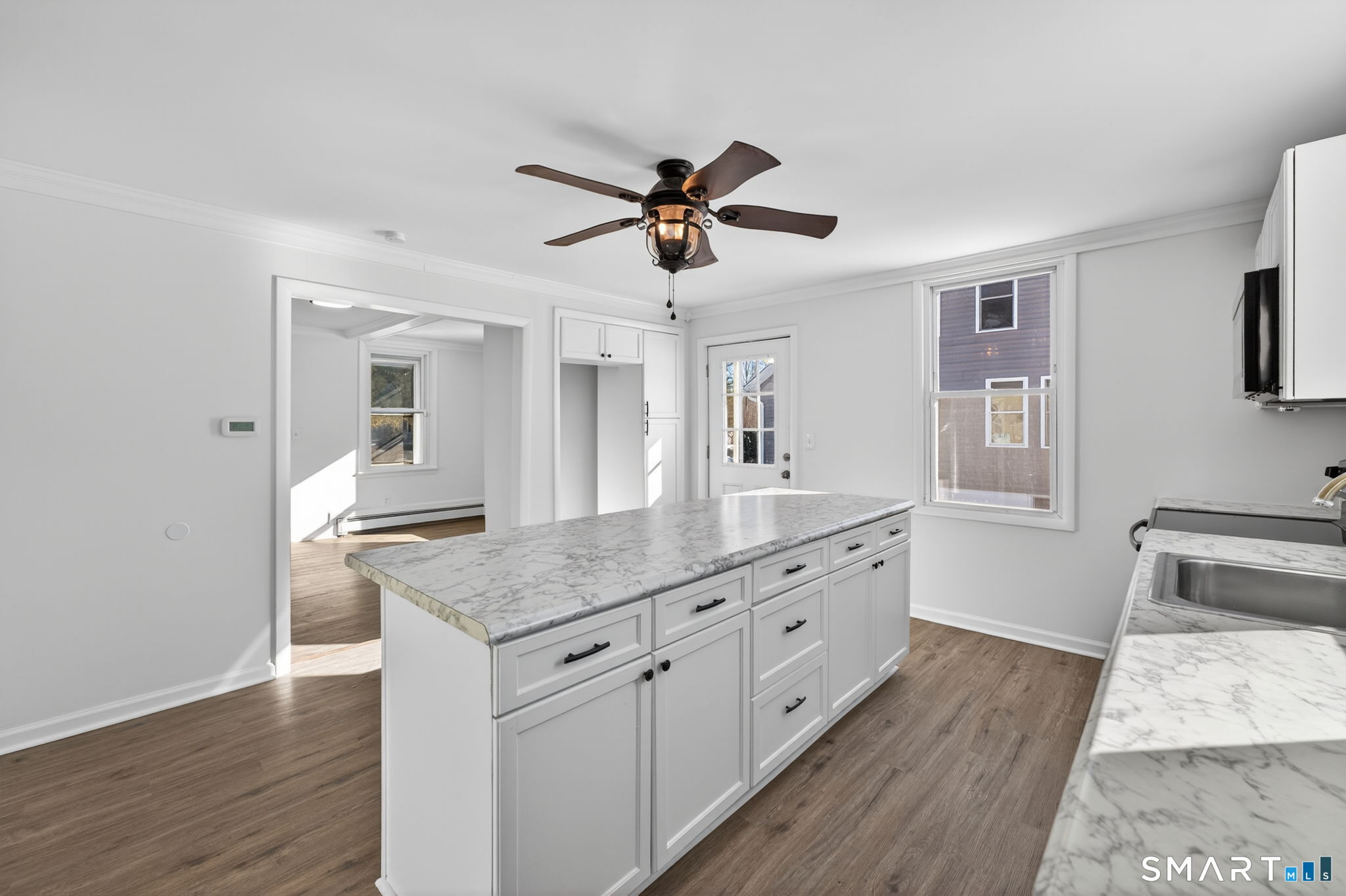 119 Taftville-Occum Road Norwich, CT 06360 - Photo 6 of 27 a kitchen with sink cabinets and wooden floor