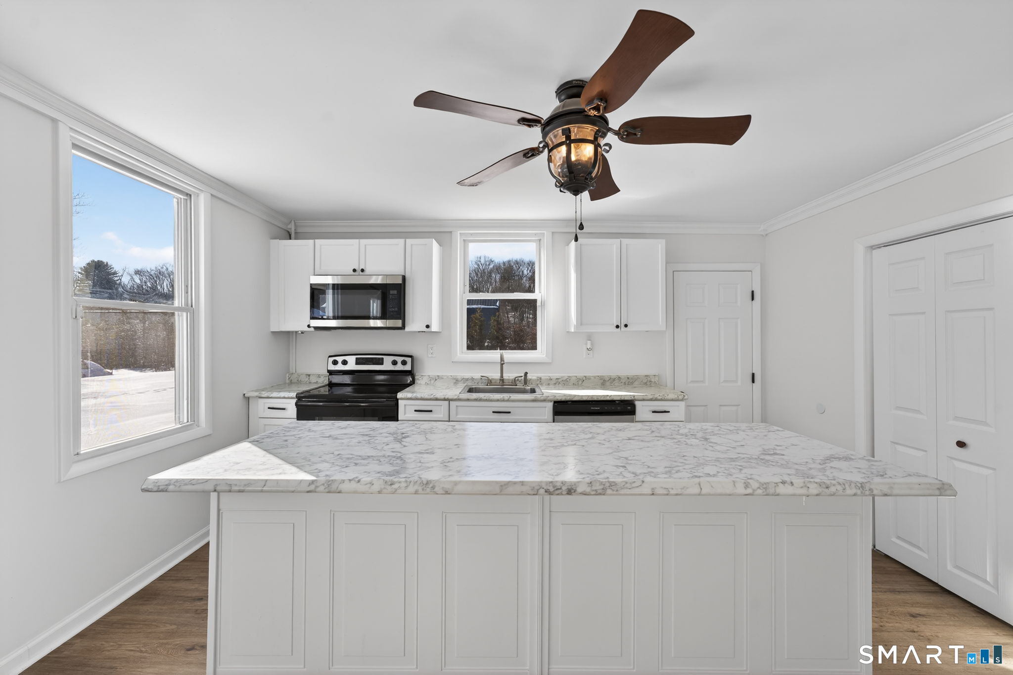 119 Taftville-Occum Road Norwich, CT 06360 - Photo 7 of 27 a kitchen with stainless steel appliances granite countertop a stove a sink and a microwave