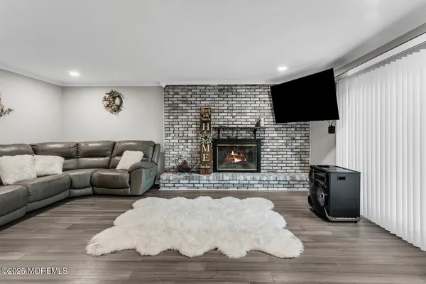 a living room with furniture a flat screen tv and a fireplace