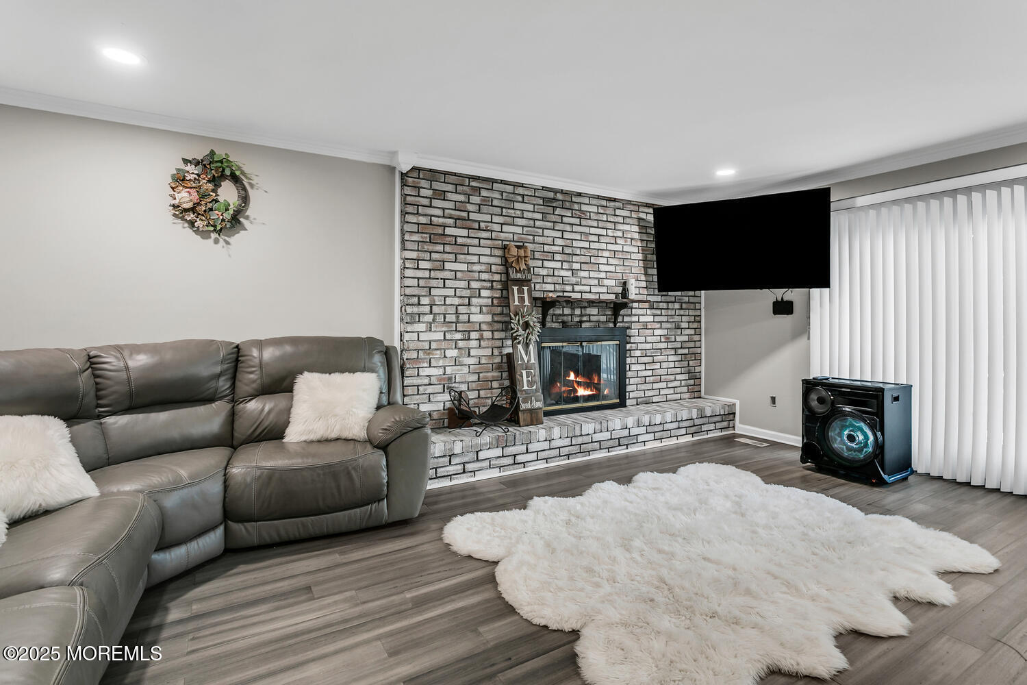 3 Lisa Drive Hazlet, NJ 07730 - Photo 12 of 30 a living room with furniture a flat screen tv and a fireplace