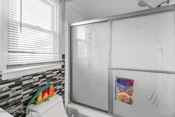 a utility room with a window and a shower
