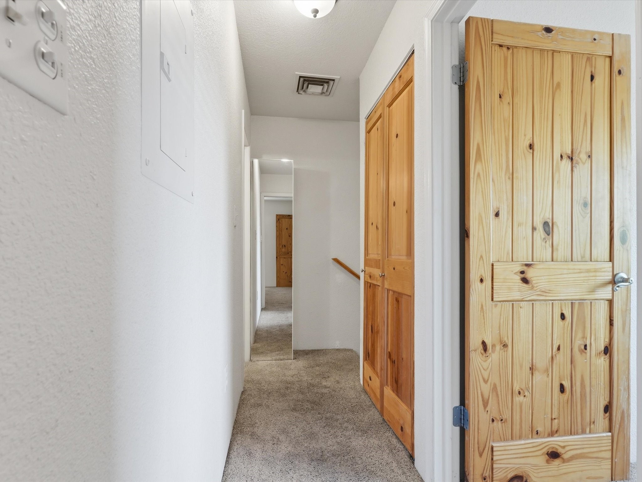 2210 Miguel Chavez Road, Unit 411 Santa Fe, NM 87505 - Photo 19 of 59 Hallway that leads you to the bathrooms, primary bedroom, and the second bedroom located upstairs