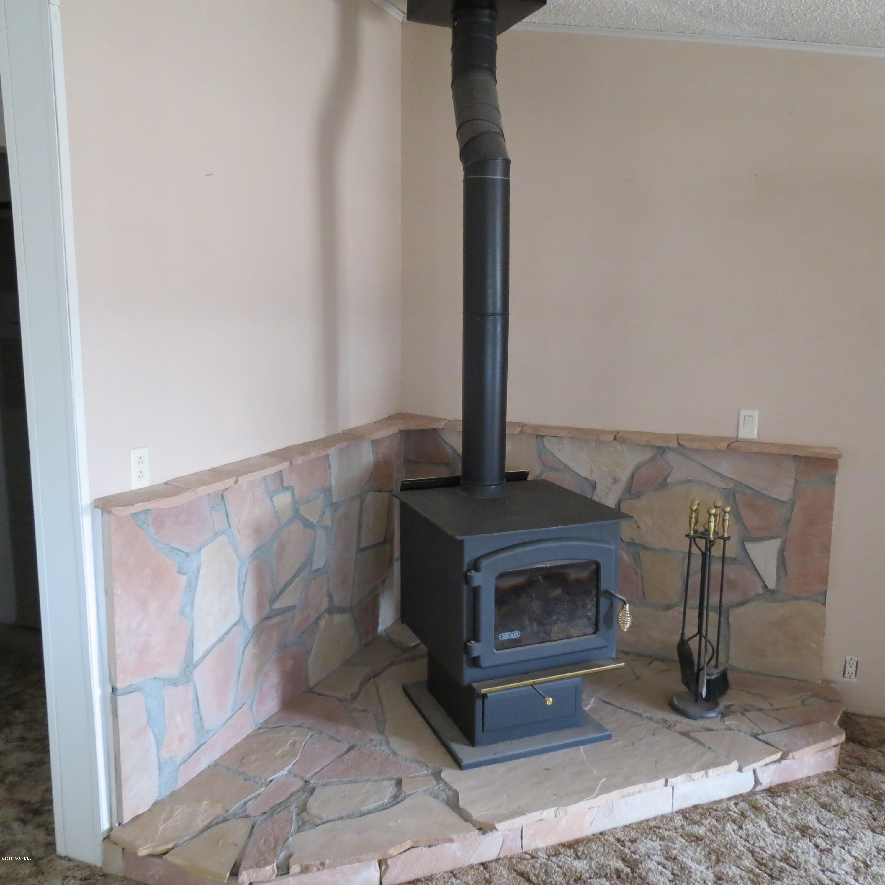 1400 Saddle Road Paulden, AZ 86334 - Photo 9 of 28 a living room with a fireplace