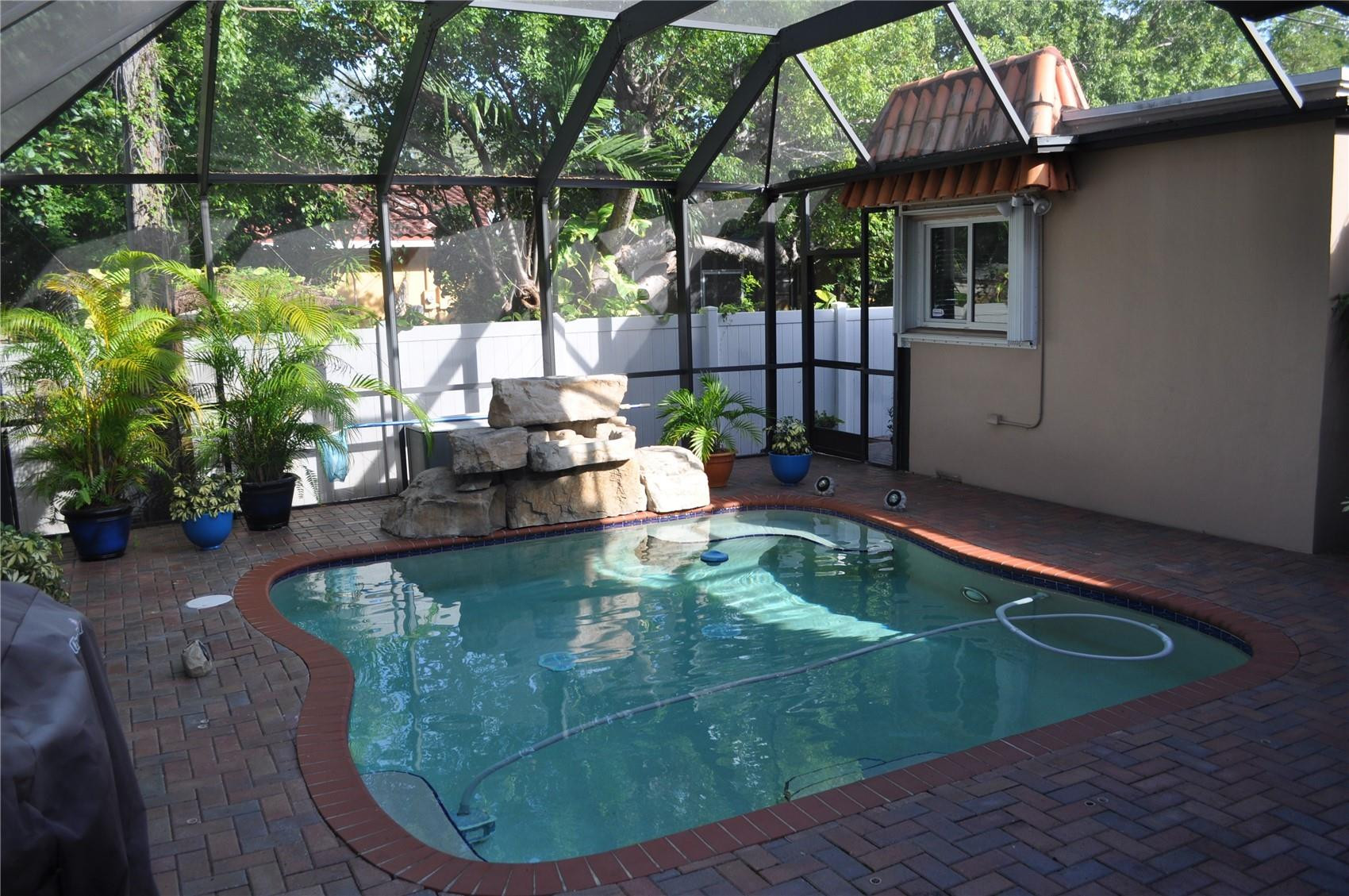2175 Northeast 185th Street Miami, FL 33180 - Photo 30 of 32 Screened in heated waterfall pool
