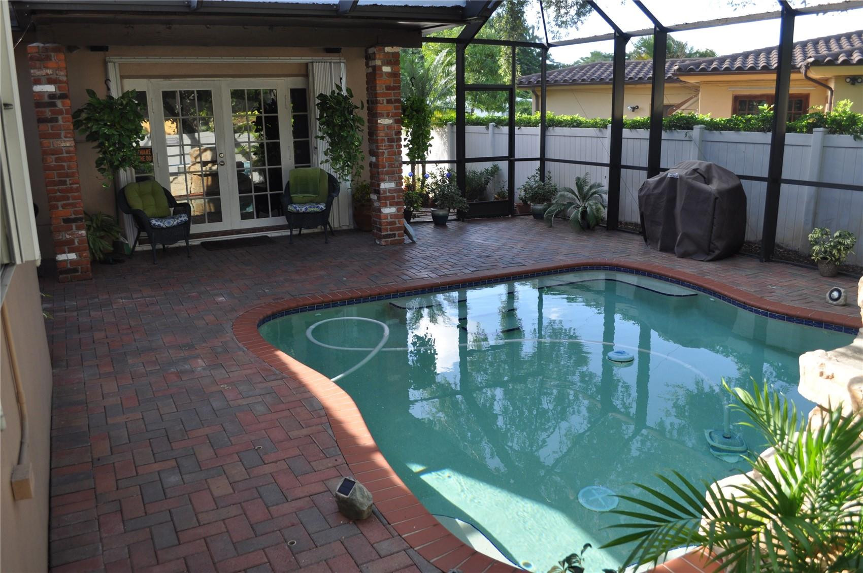 2175 Northeast 185th Street Miami, FL 33180 - Photo 32 of 32 Screened in heated waterfall pool