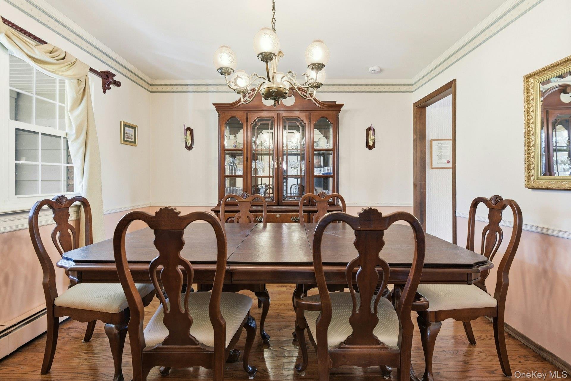 35 East Neck Road Huntington, NY 11743 - Photo 19 of 41 a view of a dining room with furniture and chandelier