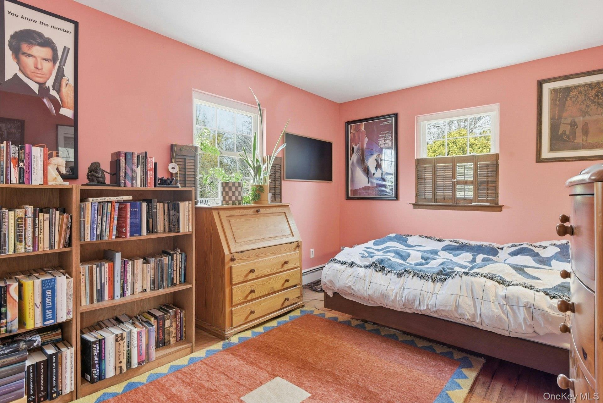 35 East Neck Road Huntington, NY 11743 - Photo 23 of 41 a bedroom with a bed furniture and a book shelf