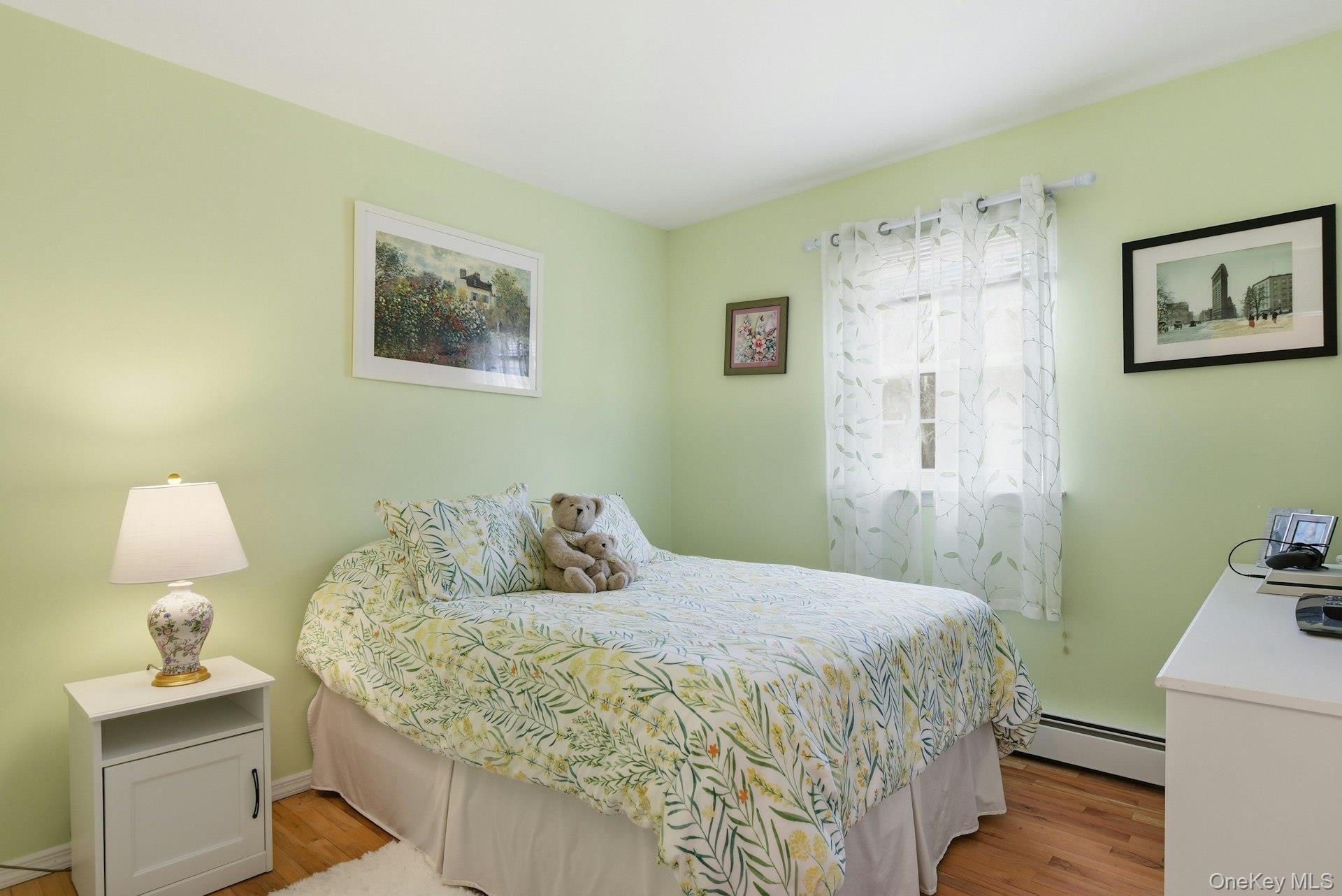 35 East Neck Road Huntington, NY 11743 - Photo 25 of 41 a bedroom with a bed and a lamp on the dresser