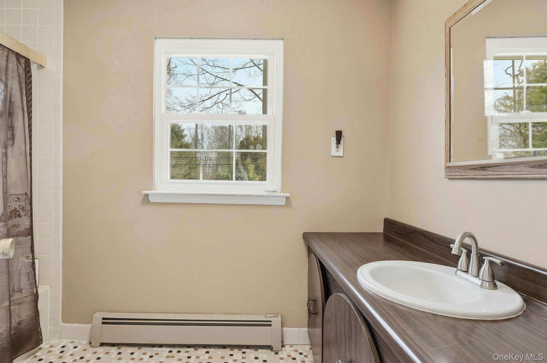 35 East Neck Road Huntington, NY 11743 - Photo 26 of 41 a bathroom with a sink and a mirror