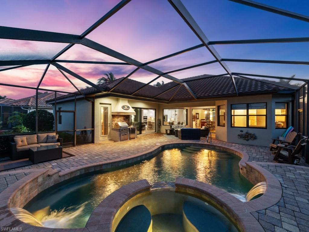 9430 Italia Way Naples, FL 34113 - Photo 26 of 47 View of pool with a pool with connected hot tub, a patio area, outdoor lounge area, and an outdoor kitchen