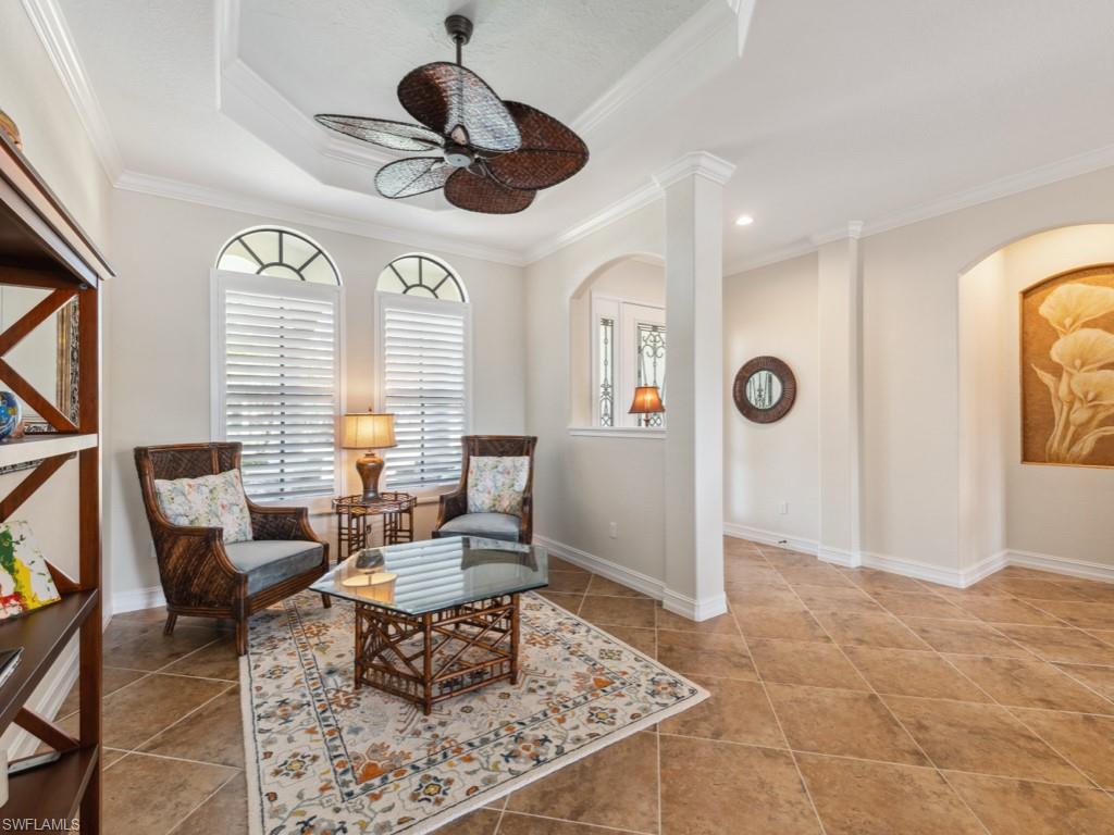 9430 Italia Way Naples, FL 34113 - Photo 8 of 47 Sitting room with a ceiling fan, tile patterned flooring, and arched walkways