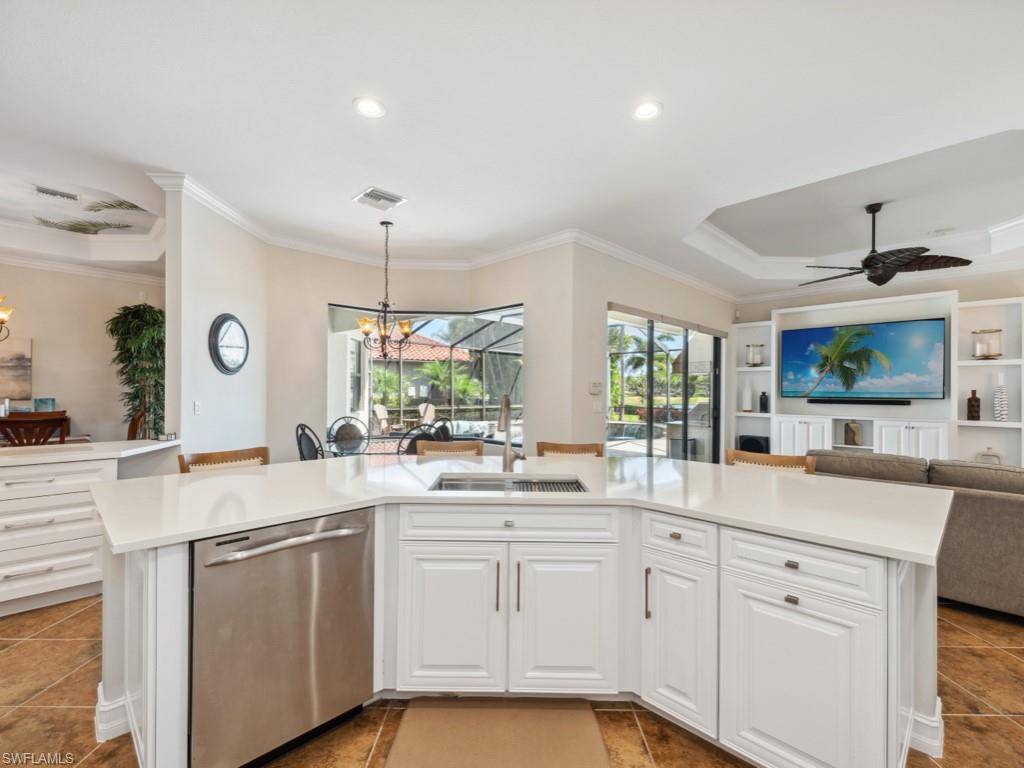 9430 Italia Way Naples, FL 34113 - Photo 47 of 47 Kitchen with open floor plan, dishwasher, light countertops, and a sink
