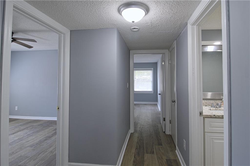 122 Rue Fontaine Lithonia, GA 30038 - Photo 13 of 36 a view of a hallway with wooden floor