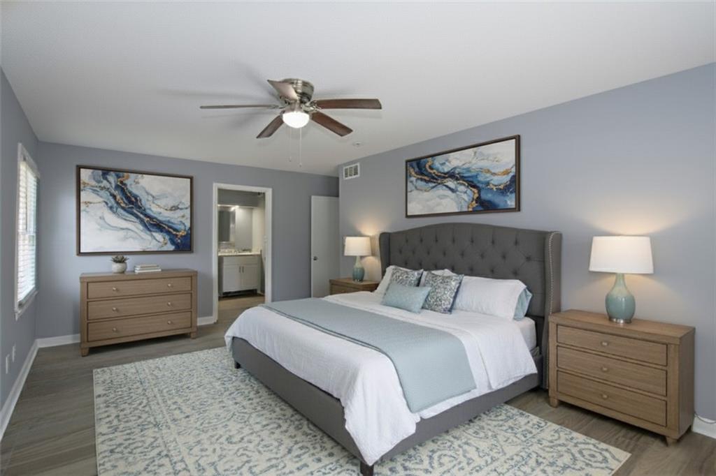 122 Rue Fontaine Lithonia, GA 30038 - Photo 18 of 36 a bedroom with a bed and a chandelier