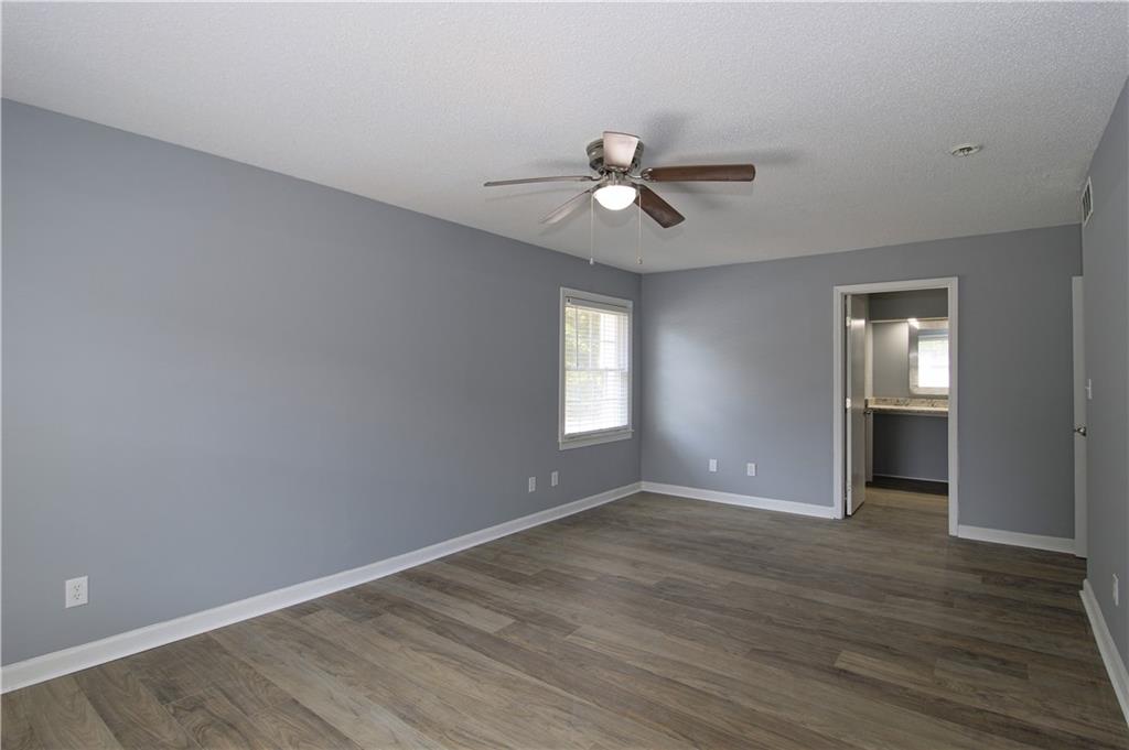 122 Rue Fontaine Lithonia, GA 30038 - Photo 20 of 36 a view of empty room with wooden floor and ceiling fan