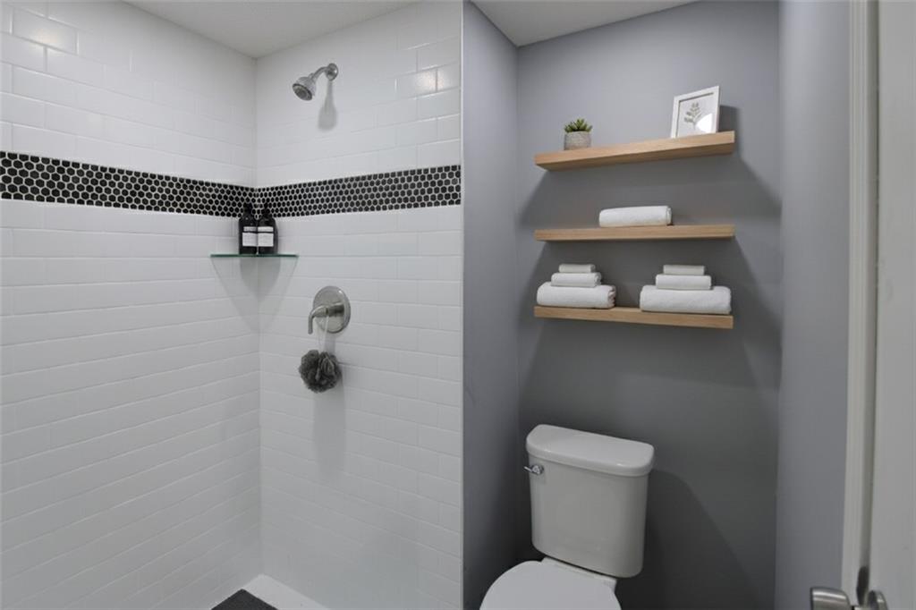 122 Rue Fontaine Lithonia, GA 30038 - Photo 23 of 36 a bathroom with a toilet and a shower