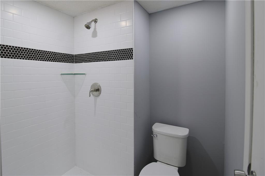 122 Rue Fontaine Lithonia, GA 30038 - Photo 24 of 36 a bathroom with a toilet and a shower