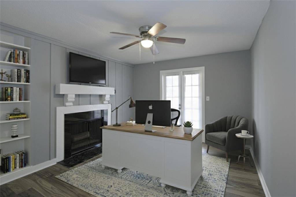 122 Rue Fontaine Lithonia, GA 30038 - Photo 25 of 36 a living room with furniture a flat screen tv and a fireplace