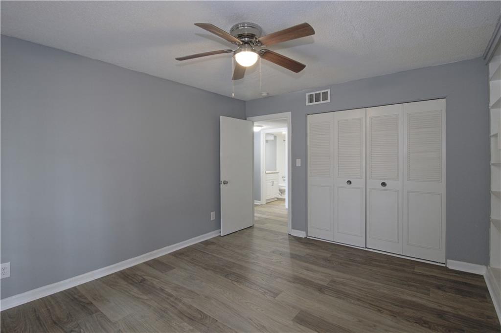 122 Rue Fontaine Lithonia, GA 30038 - Photo 27 of 36 a view of an empty room with wooden floor